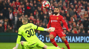 Mohamed Salah scored his 50th European goal for Liverpool as the Reds booked their place in the last 16 of the Champions League with victory over 10-man Lille at Anfield.